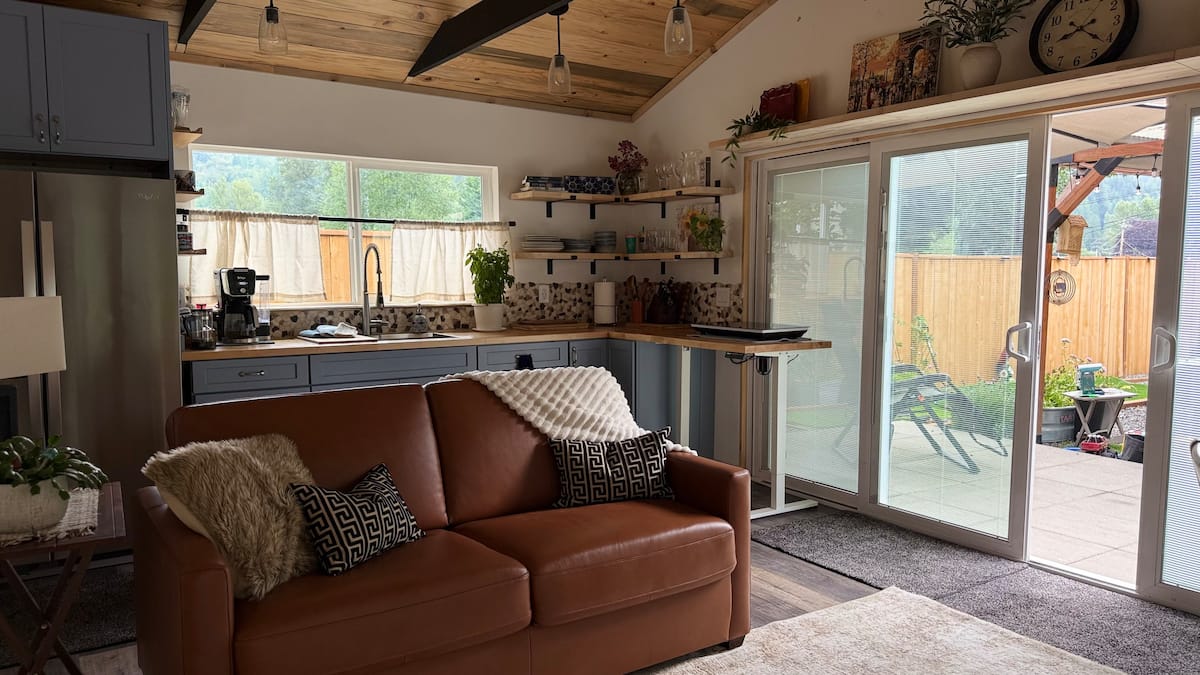 Living room with sofa and doors opening to the garden